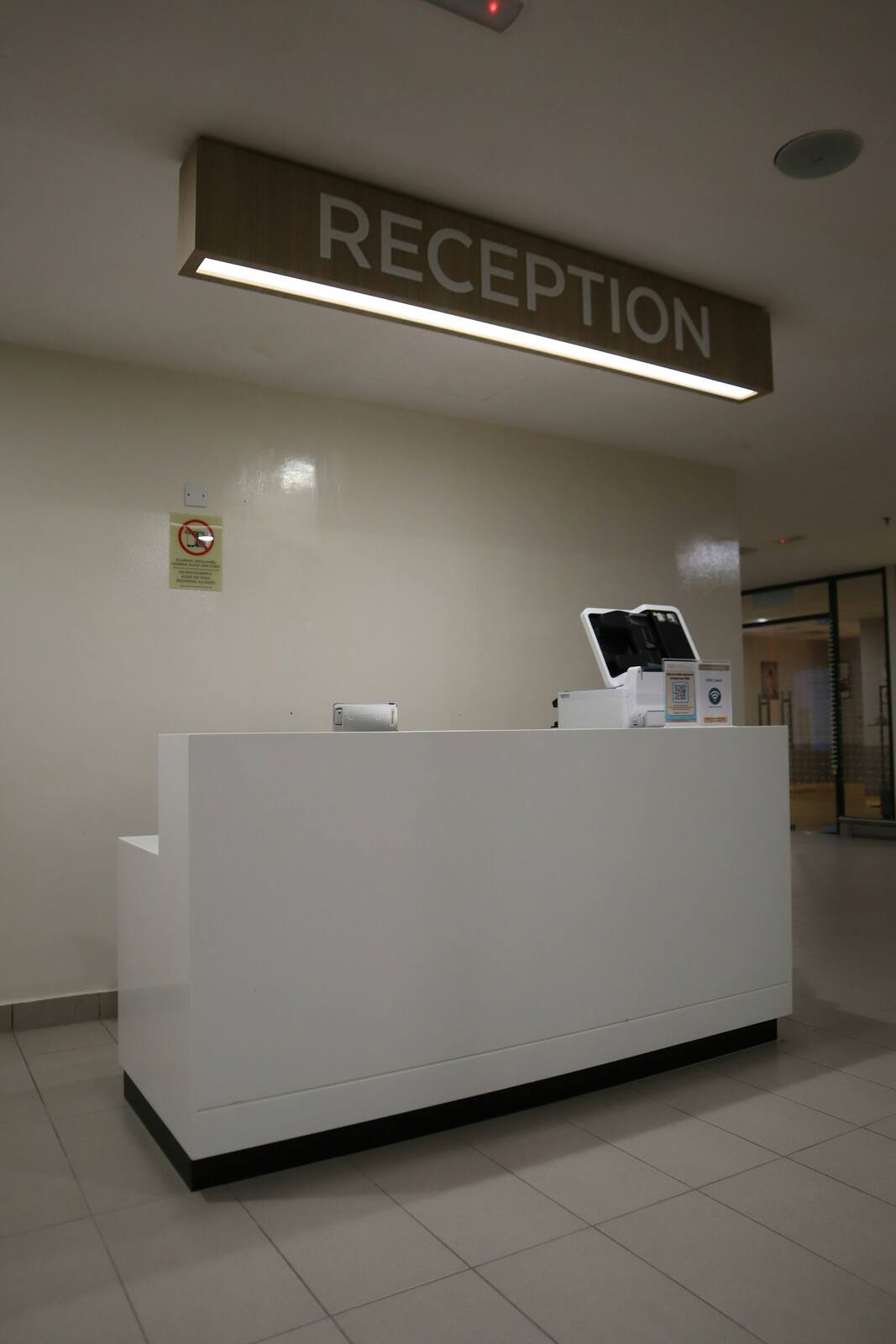Inside the Carlton North rooms — a quiet, minimal reception with pale walls and natural light.