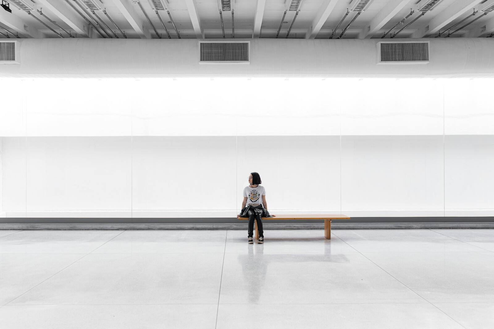 The Meridian Health Rooms reception in daylight — a calm, uncluttered space with pale timber, soft natural light and a long bench by the window.