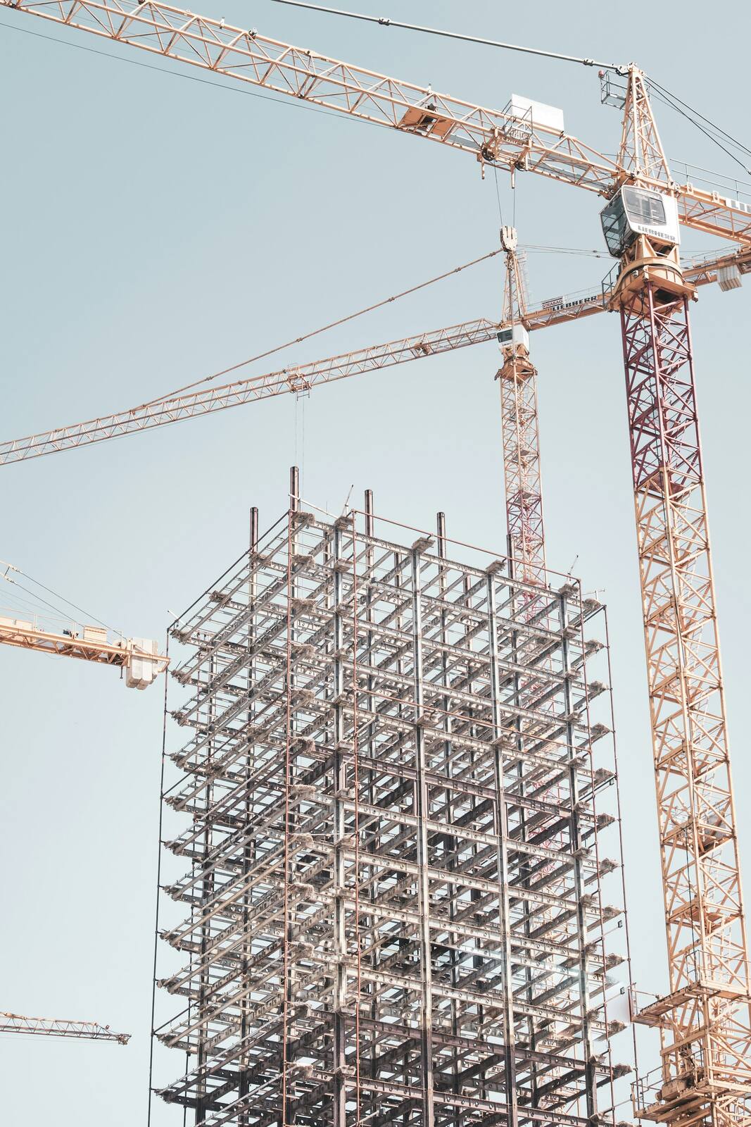 Concrete pour with a crane on an industrial knockdown-rebuild site.