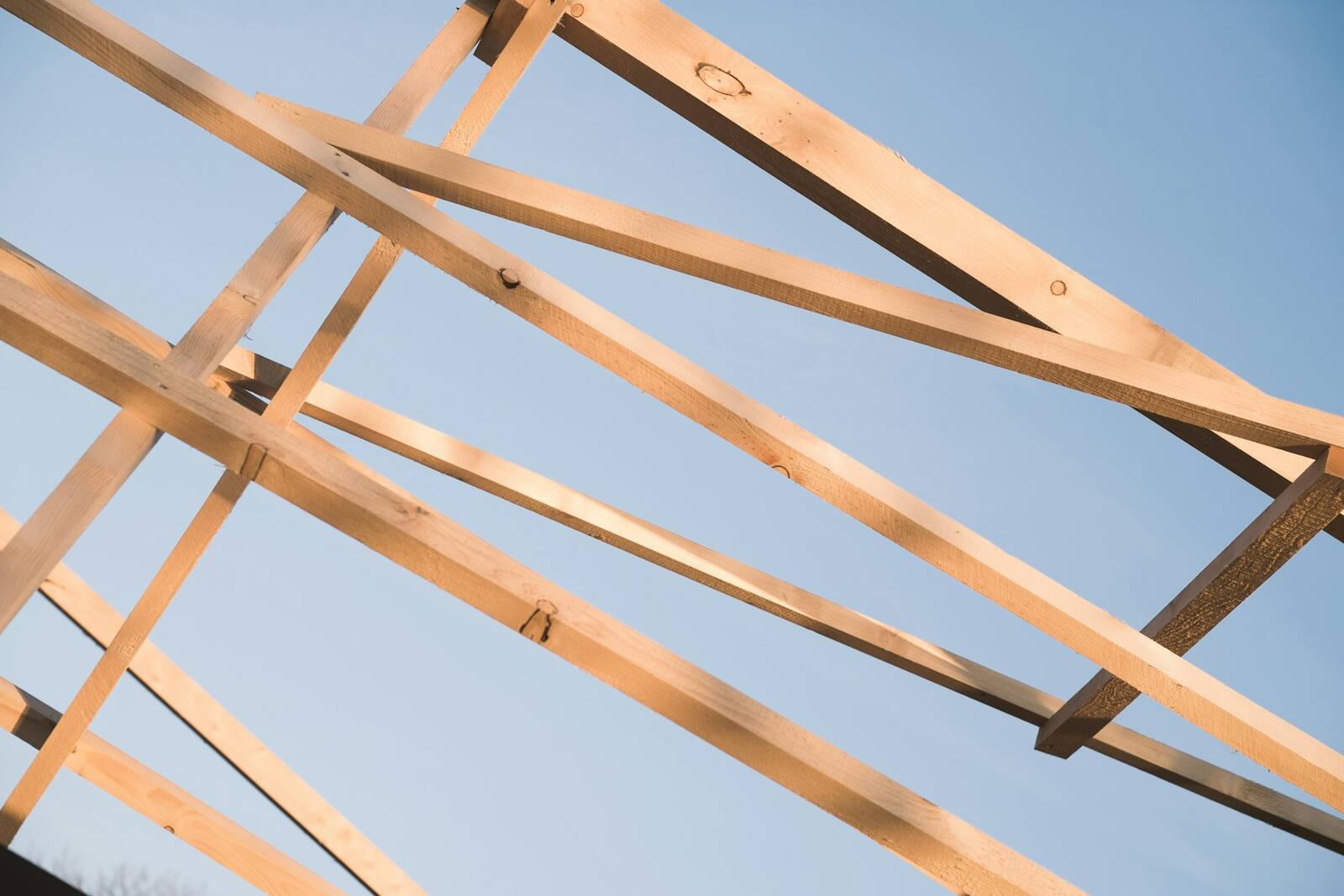 Warm timber-framed structure of a double-storey extension mid-build.