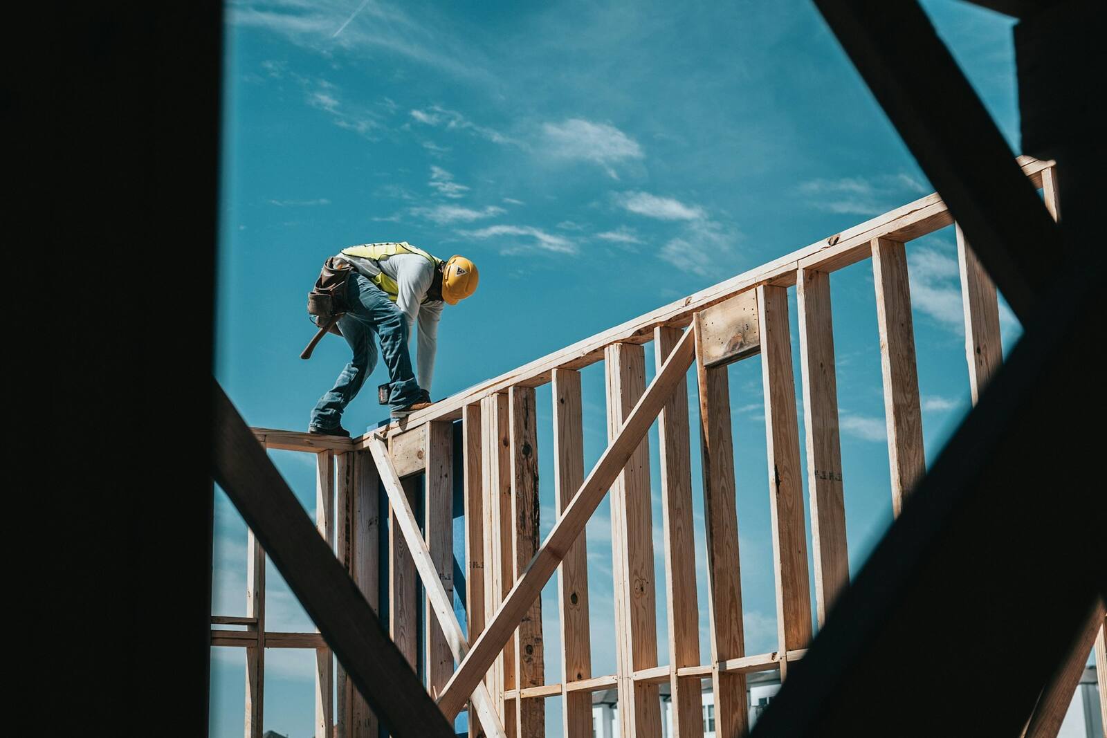 Steel frame skeleton of a new build standing against an open Melbourne sky.
